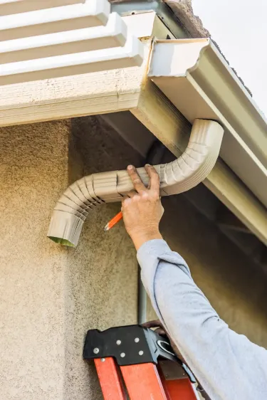 Securing gutter system to fascia